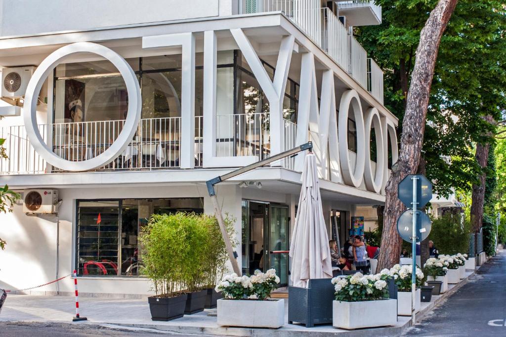 a building with an umbrella on the side of the street at Hotel Hollywood Convenzionato Aquafan in Riccione