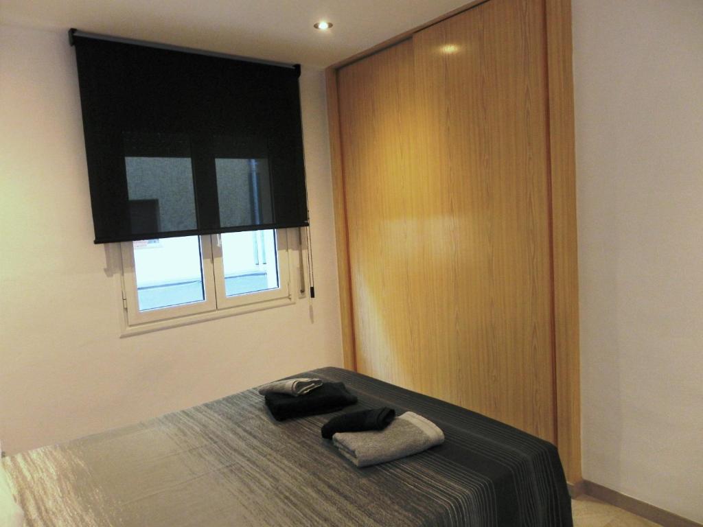 A bed or beds in a room at Apartament Margarit