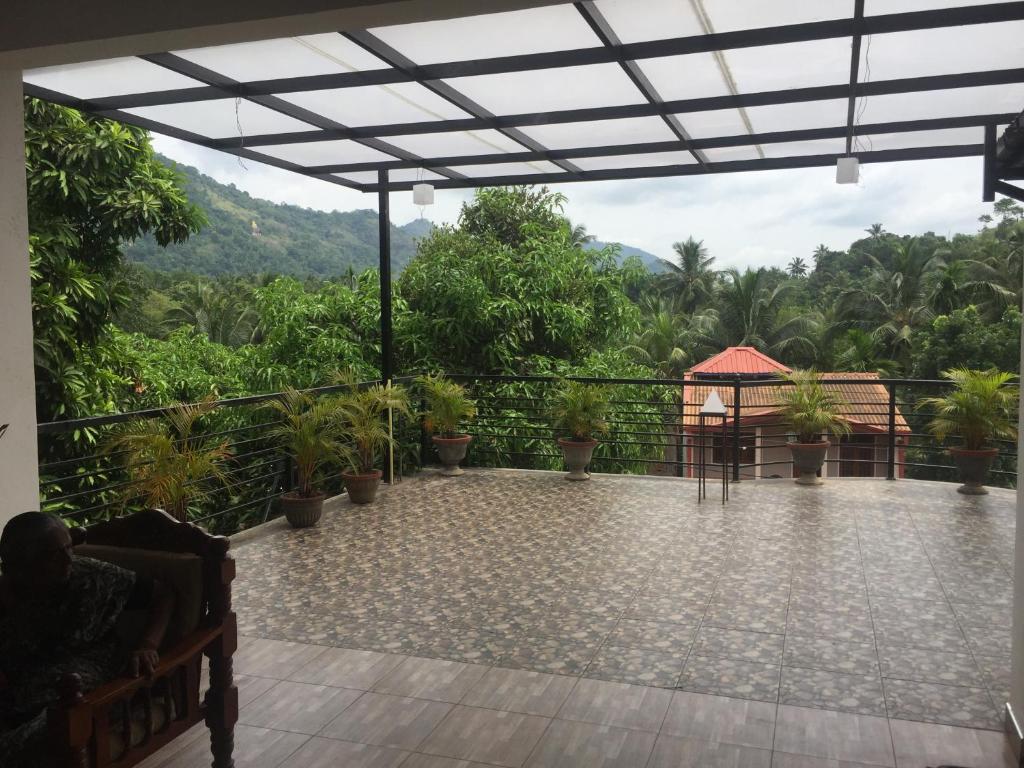 a patio with a view of a mountain at A&B Events Guest in Matale