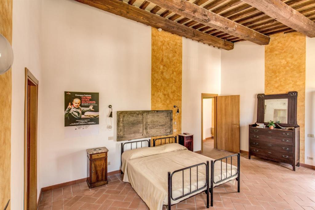 a bedroom with a bed and a dresser and a mirror at ecOstello Magliano Sabina in Magliano Sabina