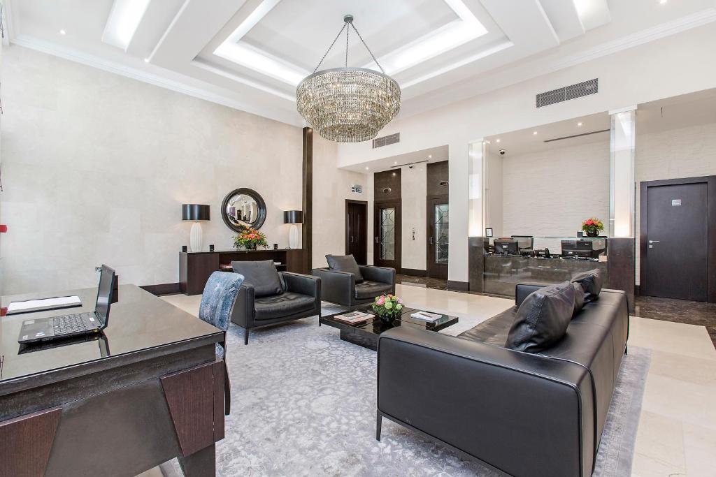 a living room with a couch and a table at 130 Queen's Gate Apartments in London