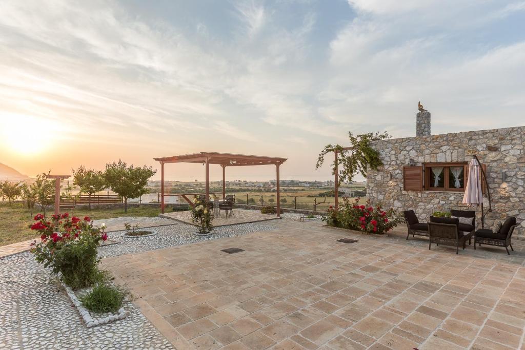 an outdoor patio with a gazebo and a building at Grand View Villa in Kardamaina