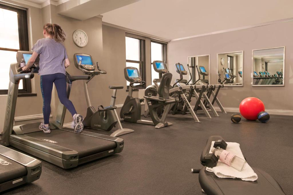 a woman running on a treadmill in a gym at Warwick New York in New York