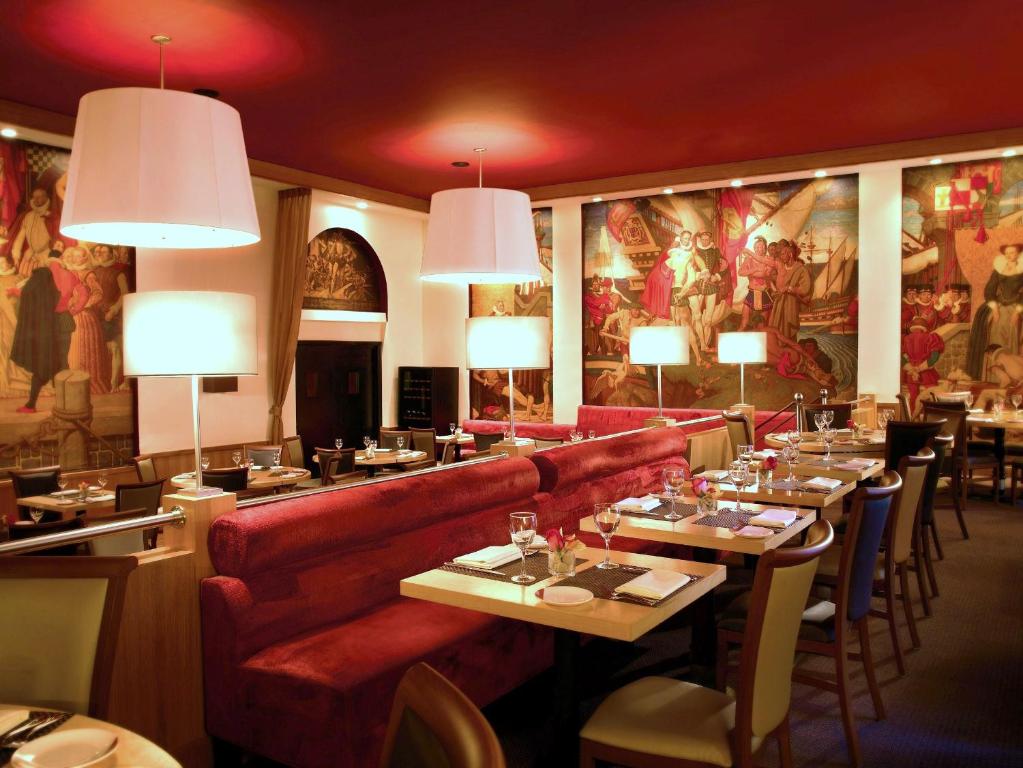 a restaurant with couches and tables in a room at Warwick New York in New York
