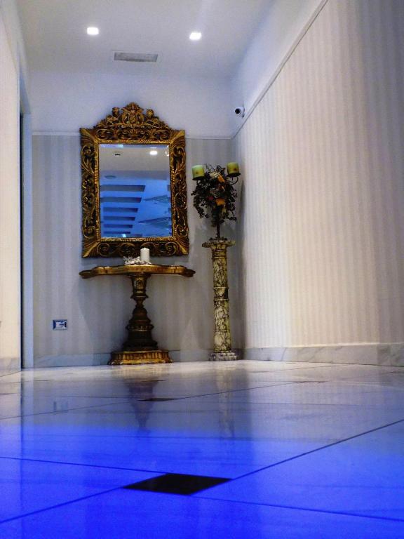 a mirror on a wall with a blue floor at Hotel Residence Villa Del Mare in Rimini