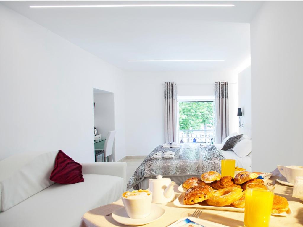 a living room with a table with food on it at San Pietro Grand Suite in Rome