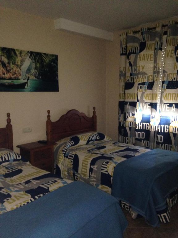 A bed or beds in a room at Pension Meson Paz
