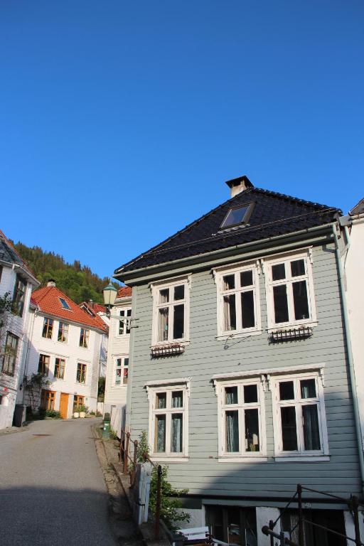 a gray house with white windows on a street at Bergen Sentrum Apartment in Bergen