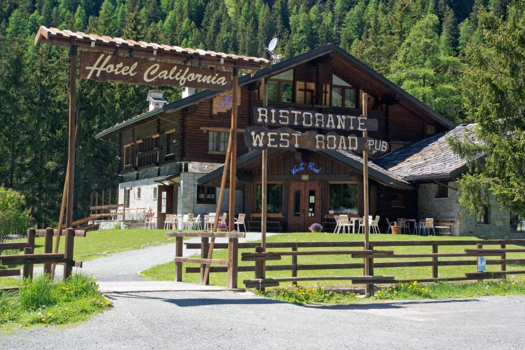 a hotel building with a sign in front of it at Hotel California in Champoluc