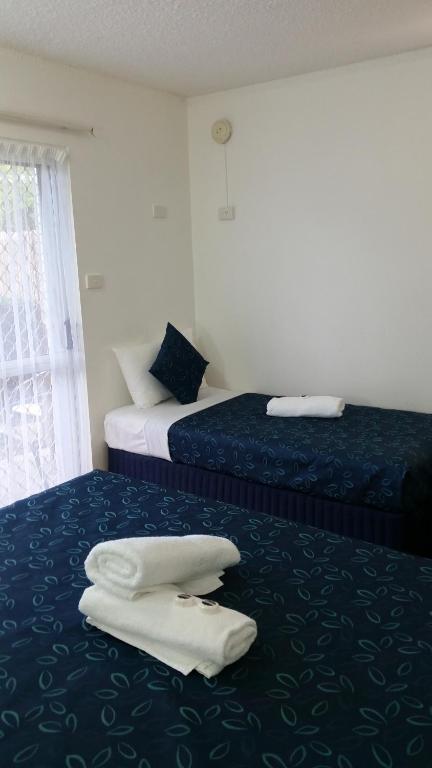 Postel nebo postele na pokoji v ubytování Cairns Gateway Resort