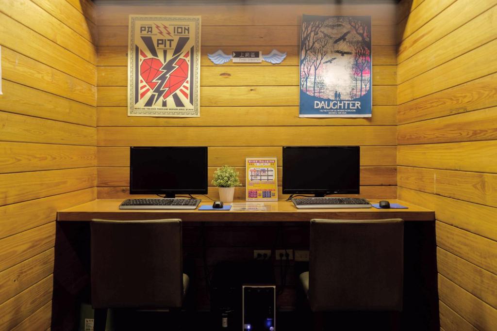 an office with two computers on a wooden wall at Angels Hostel Taipei Ximen in Taipei