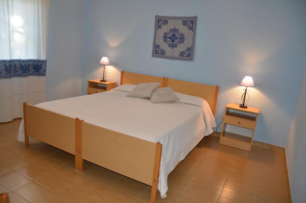 Łóżko lub łóżka w pokoju w obiekcie Vacanze Sardegna Mare San Giovanni Posada