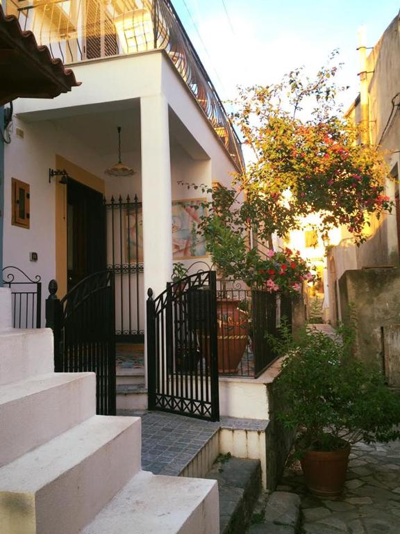 a white house with a black gate and stairs at La Casa di Ivana in San Nicola Arcella