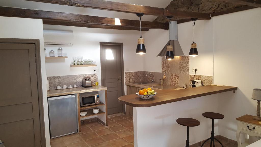 a kitchen with a counter and some stools in it at Casa Corsa in Santa-Lucia-di-Tallano