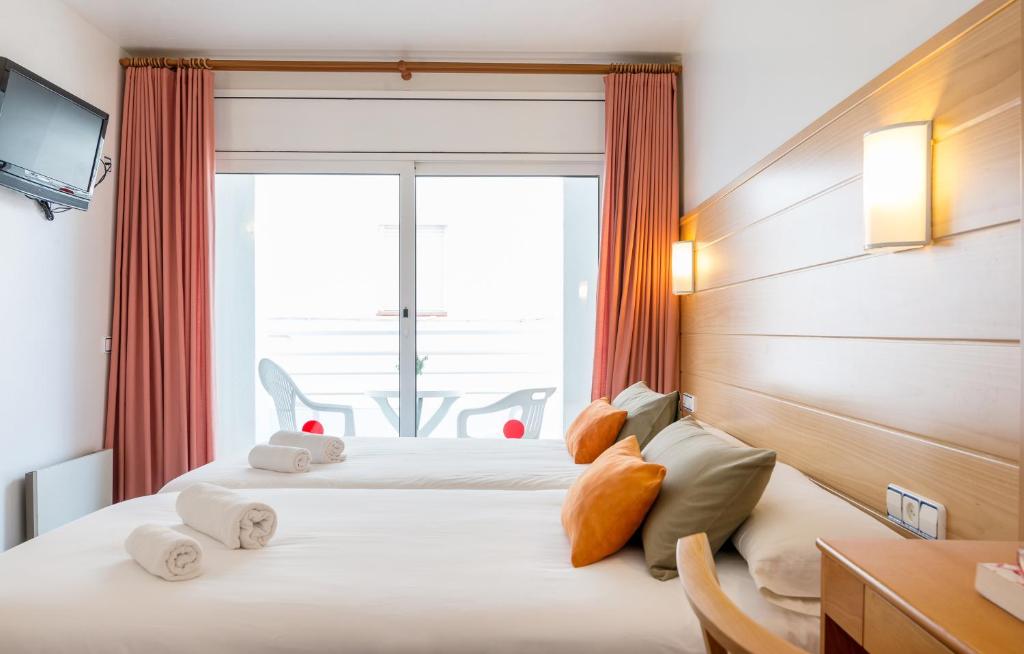 Postel nebo postele na pokoji v ubytování Hotel & Diving Les Illes