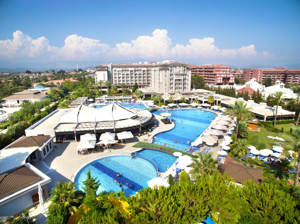 an aerial view of a resort with two pools and umbrellas at Sunis Elita Beach Resort Hotel & SPA in Kizilagac