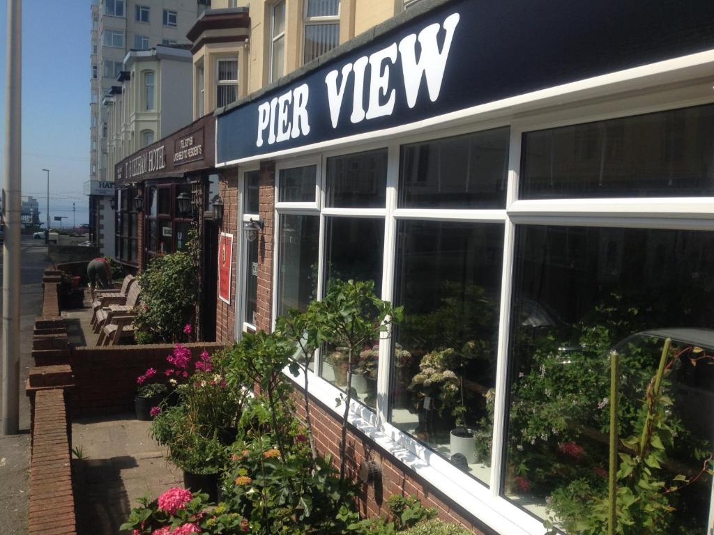 a store with a sign that reads pizza view at Pier View b&b for families in Blackpool