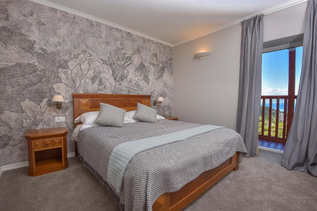 Postel nebo postele na pokoji v ubytování Hotel Draga di Lovrana