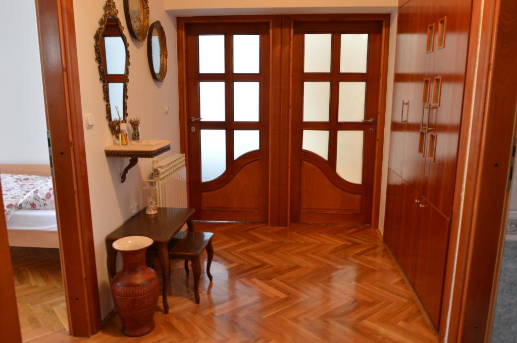 een hal met een houten deur en een tafel bij Apartment Sarah in Bihać