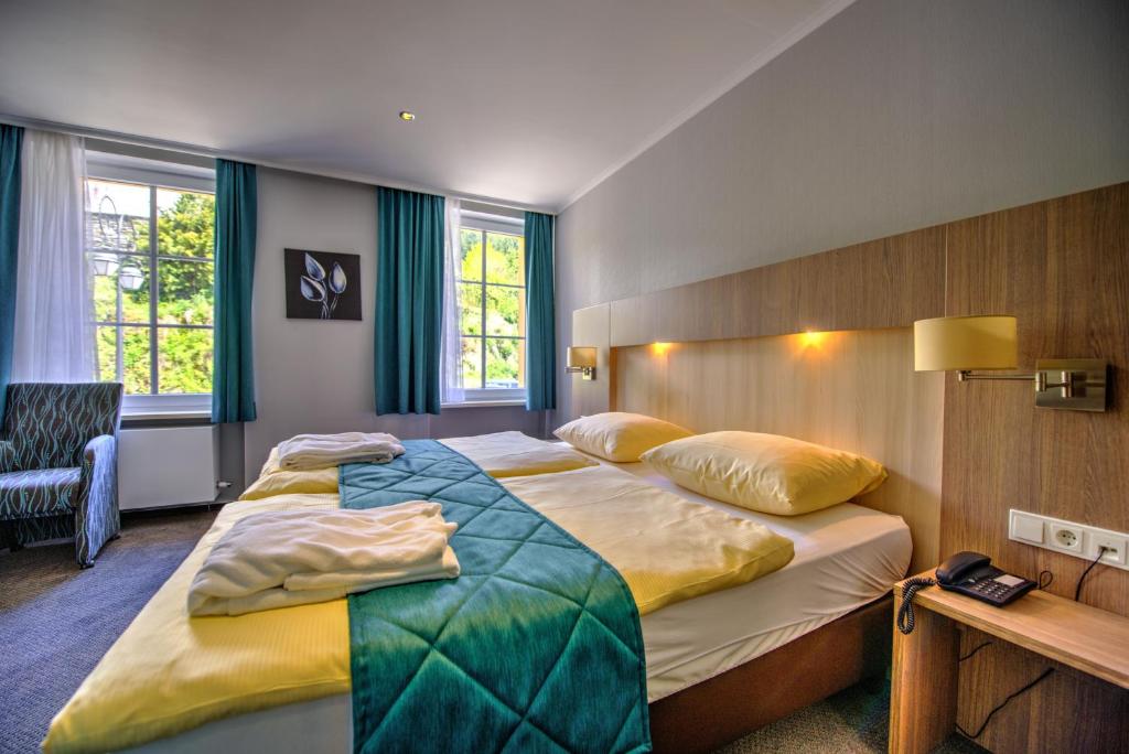 Postel nebo postele na pokoji v ubytování Hotel du Commerce - Restaurant La Table de Clervaux