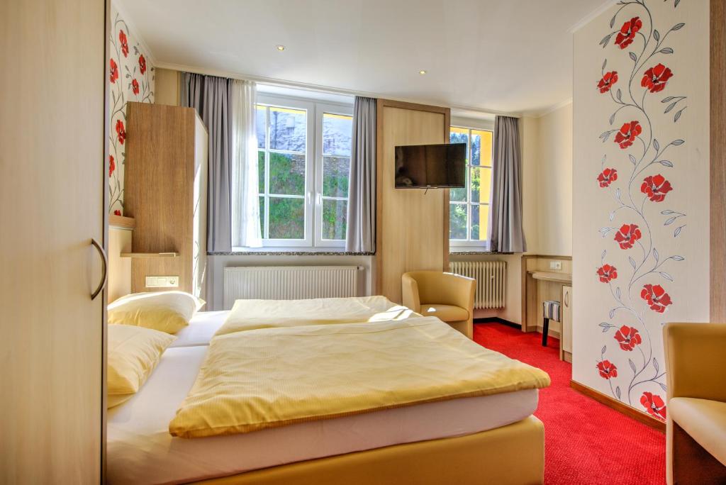 Postel nebo postele na pokoji v ubytování Hotel du Commerce - Restaurant La Table de Clervaux
