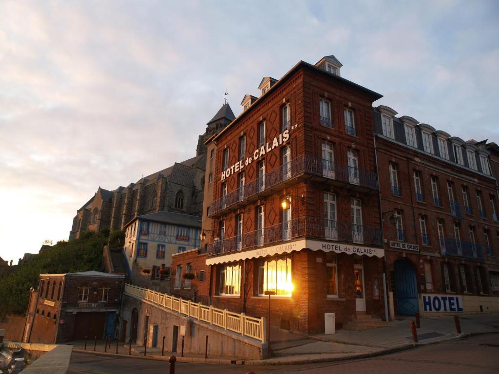 a building with a hotel on the side of it at Hôtel De Calais in Le Tréport