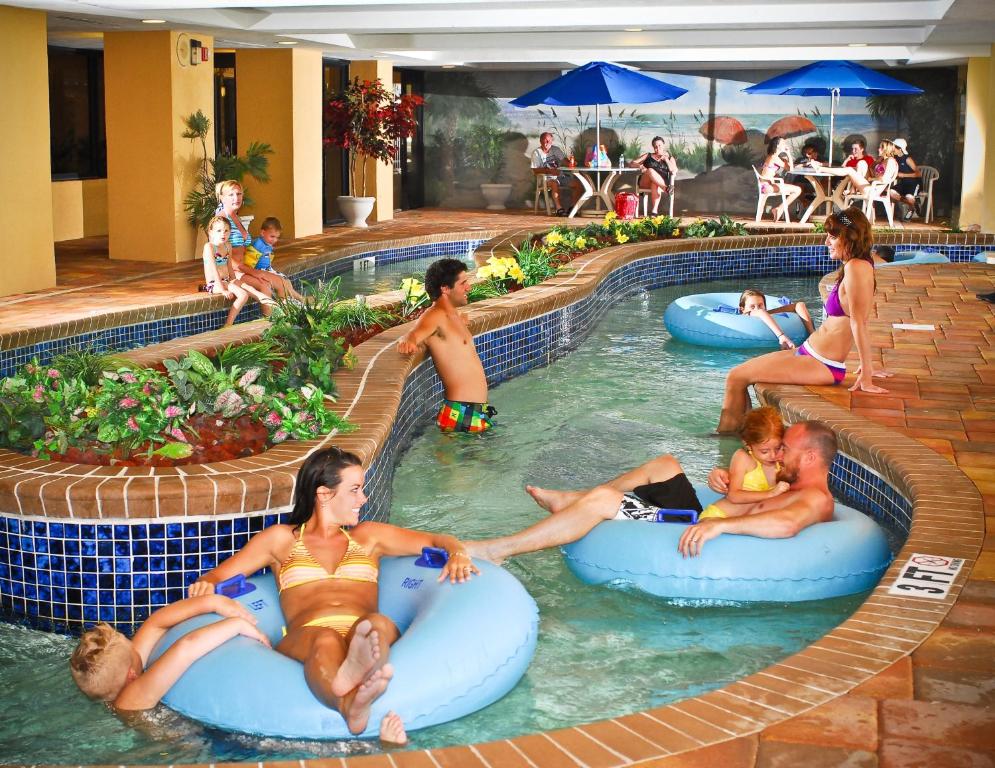 a group of people in the swimming pool at a resort at Holiday Pavilion Resort on the Boardwalk in Myrtle Beach