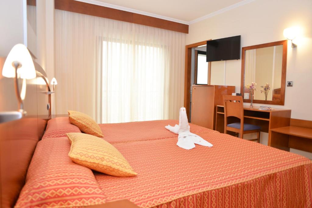 Postel nebo postele na pokoji v ubytování Hotel Portonovo