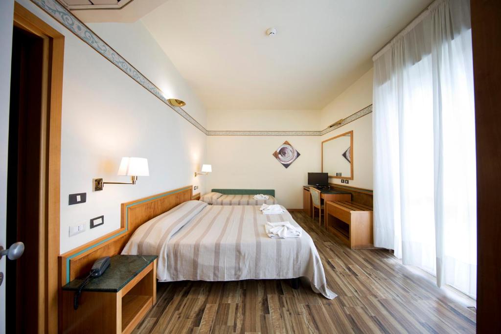 Postel nebo postele na pokoji v ubytování Hotel Marina Bay