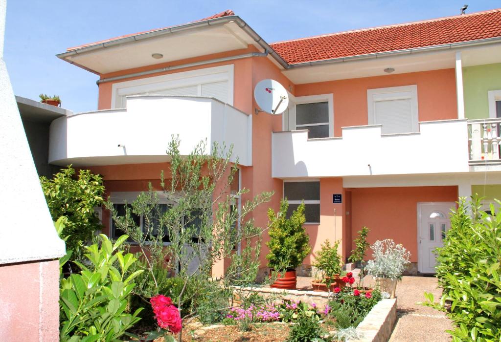 a house with a garden in front of it at Apartment Bura in Šibenik