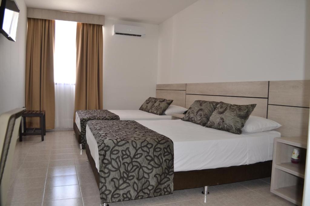 A bed or beds in a room at Hotel Kurakatá