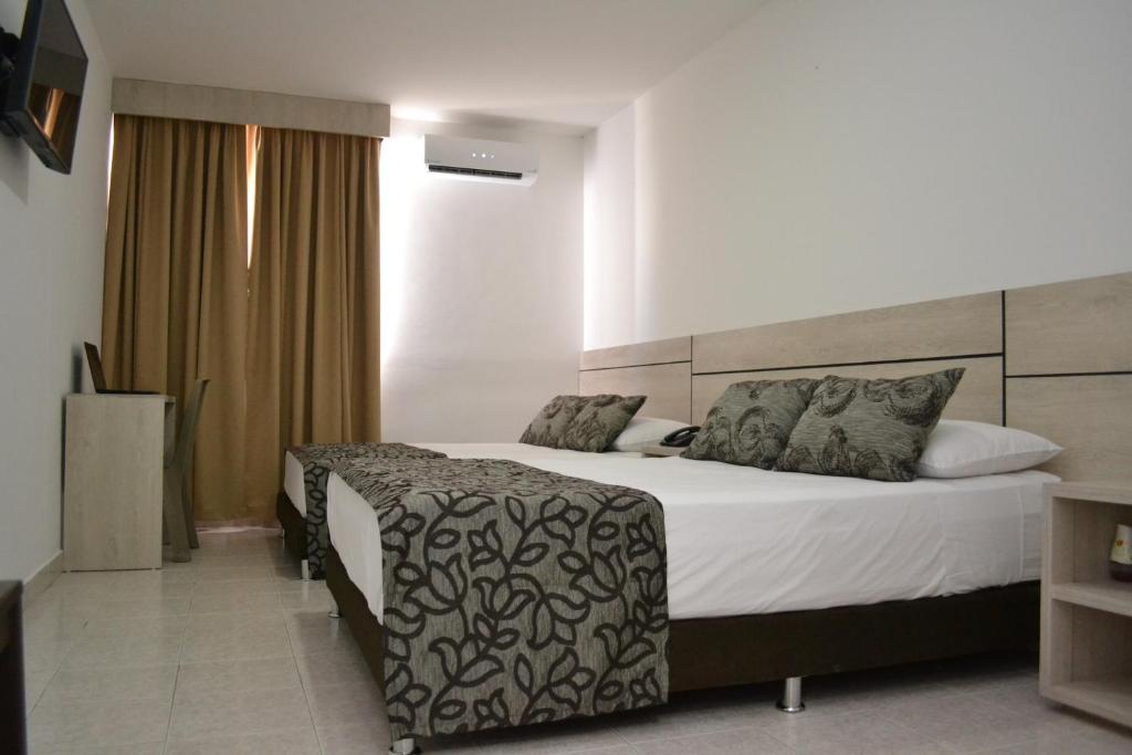 A bed or beds in a room at Hotel Kurakatá