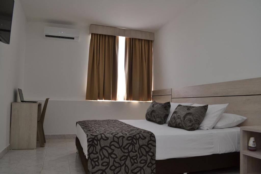 A bed or beds in a room at Hotel Kurakatá