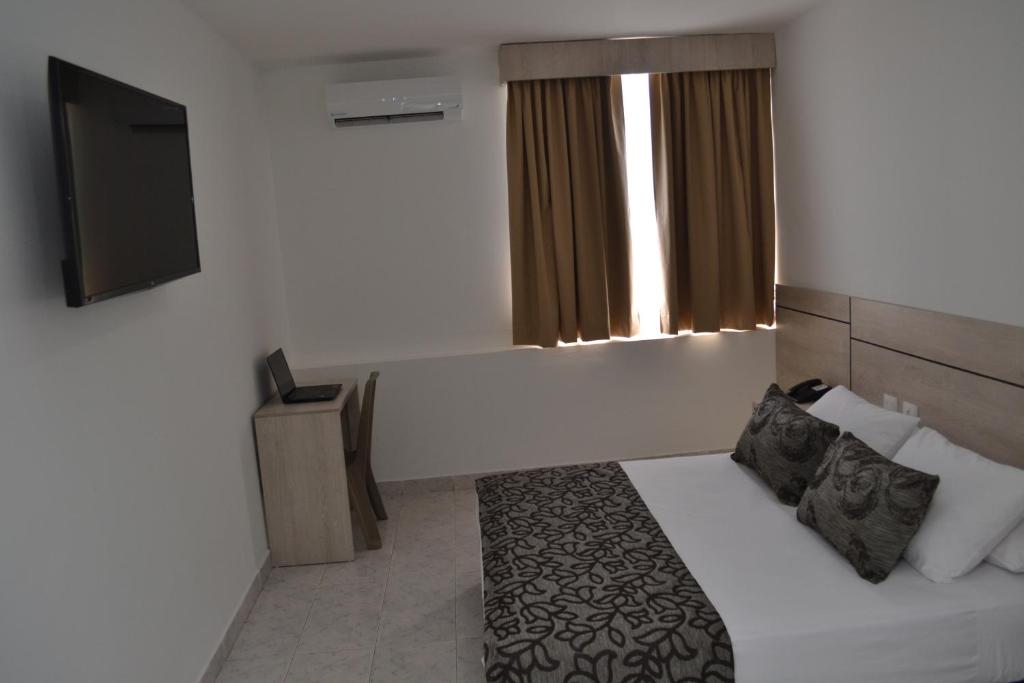 A bed or beds in a room at Hotel Kurakatá