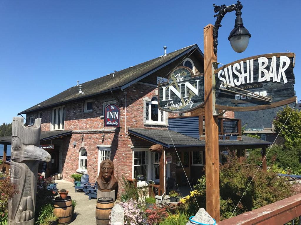 a brick building with a sign on the front of it at The Inn at Tough City in Tofino
