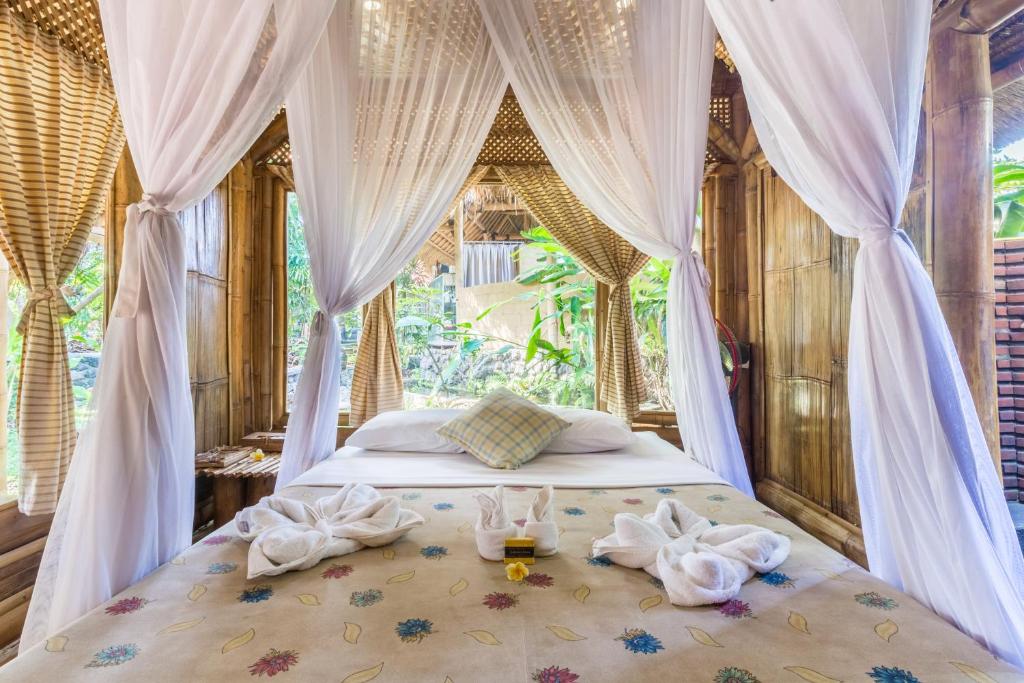 Postel nebo postele na pokoji v ubytování Omunity Bali