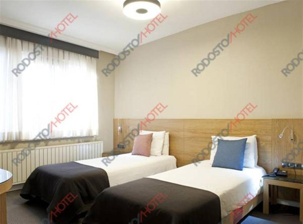 Postel nebo postele na pokoji v ubytování Rodosto Hotel