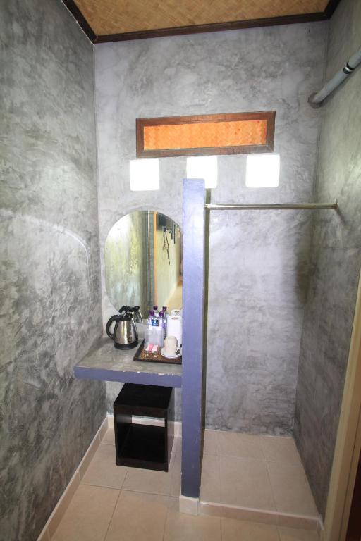 a bathroom with a shower with a sink and a mirror at Beck's Resort in Haad Pleayleam