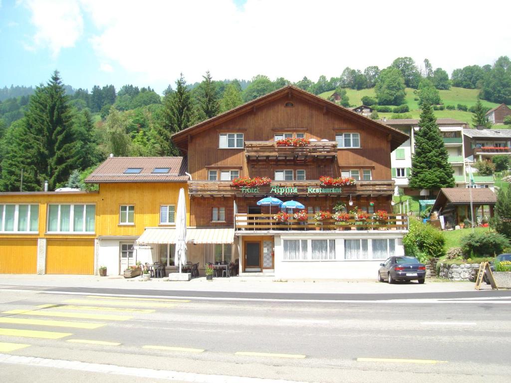 a large building on the side of a road at Hotel Alpina in Unterwasser
