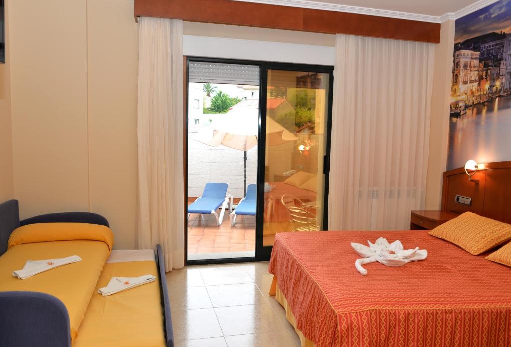 Postel nebo postele na pokoji v ubytování Hotel Portonovo