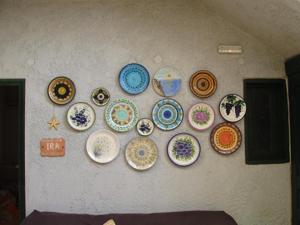 a wall with plates hanging on a wall at Aris Apartments in Gerani