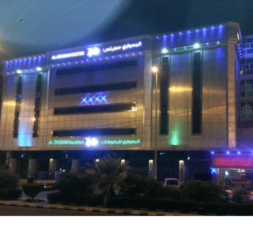 a building with blue lights on top of it at Almeswari Suites in Al Baha