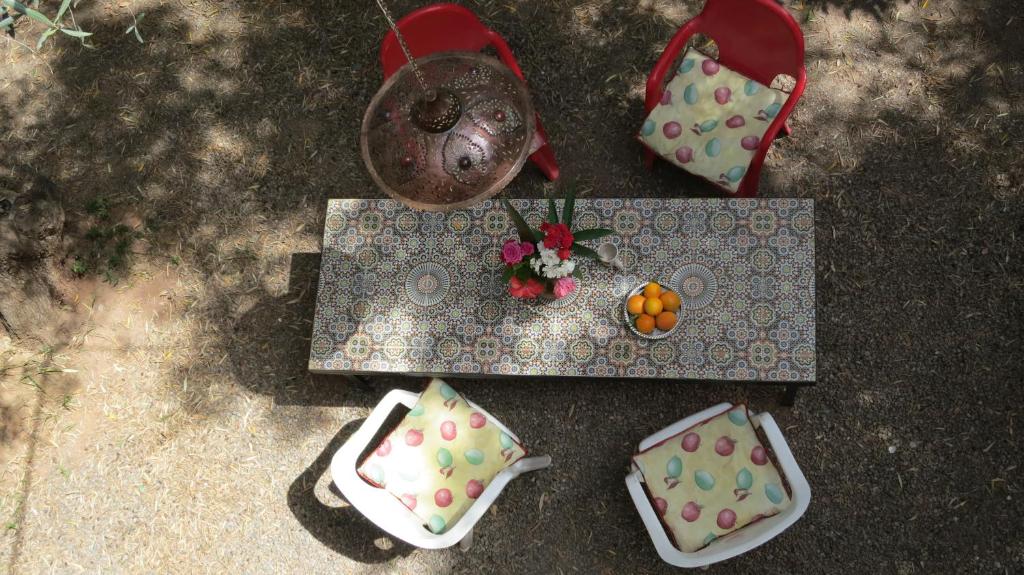 an overhead view of a table with plates and flowers at Moorish House in Aghmat
