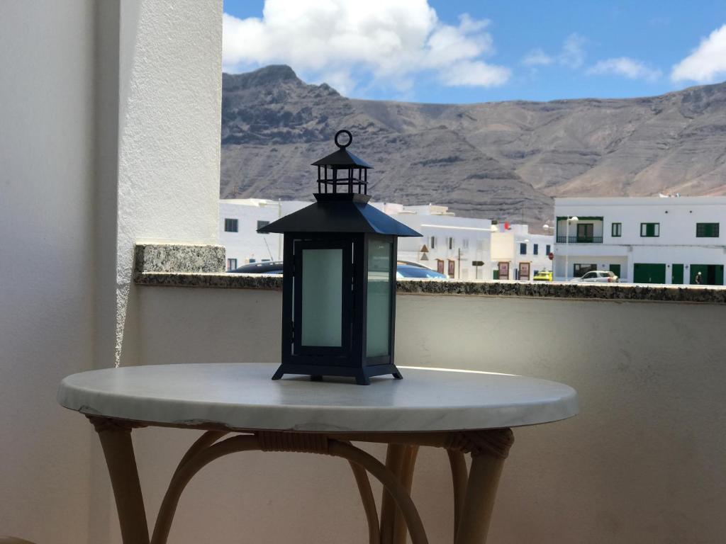 a lantern sitting on a table on a balcony at Apartamento Islote in Famara