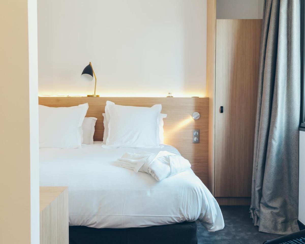 Un ou plusieurs lits dans un hébergement de l'établissement Hôtel & Spa Villa Seren