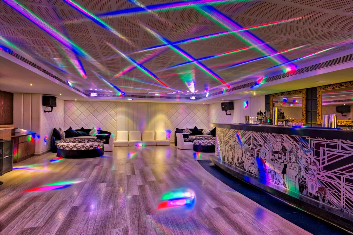 a bowling alley with colorful lights in a room at Grand Chennai by GRT Hotels in Chennai