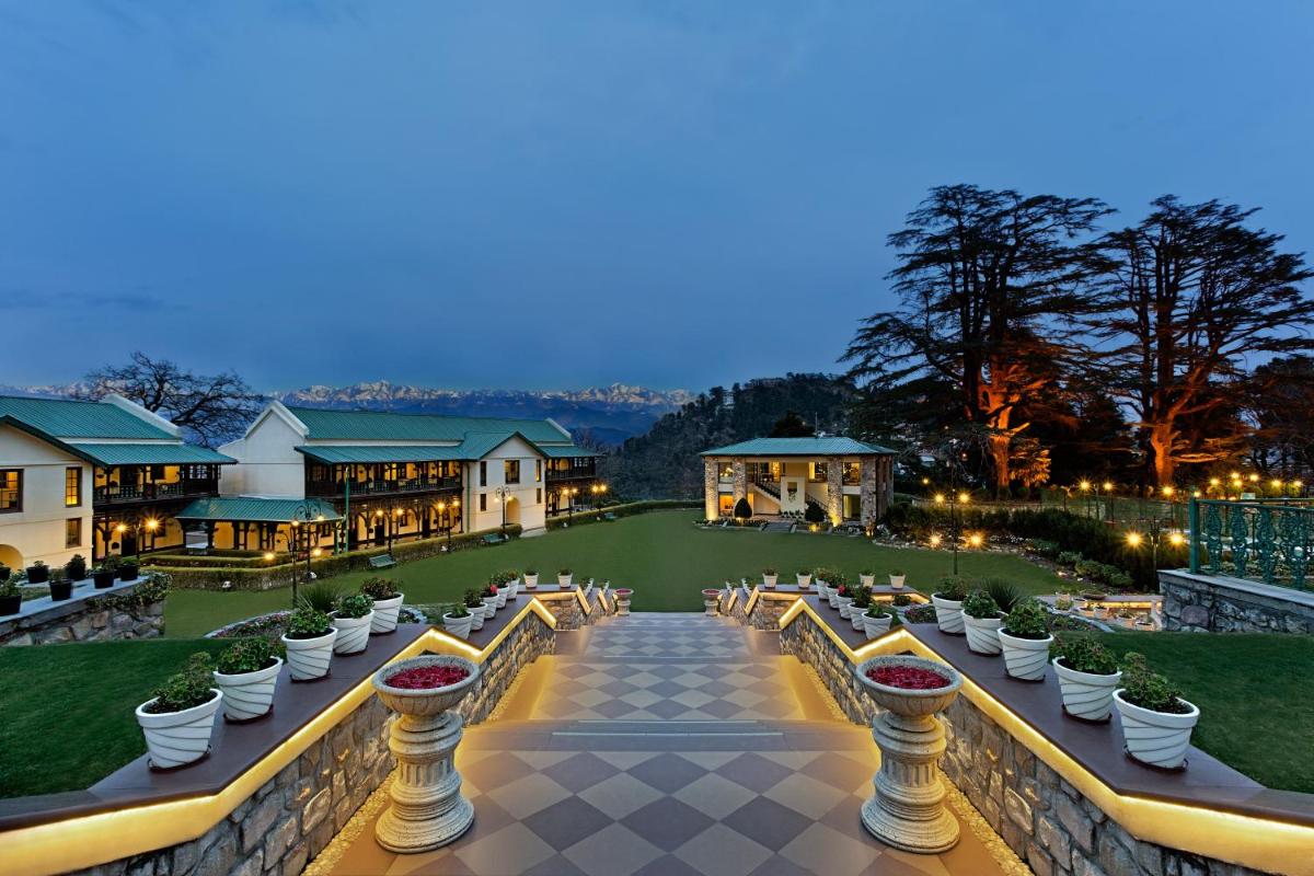 a view of a courtyard with white pots of plants at Welcomhotel by ITC Hotels, The Savoy, Mussoorie in Mussoorie