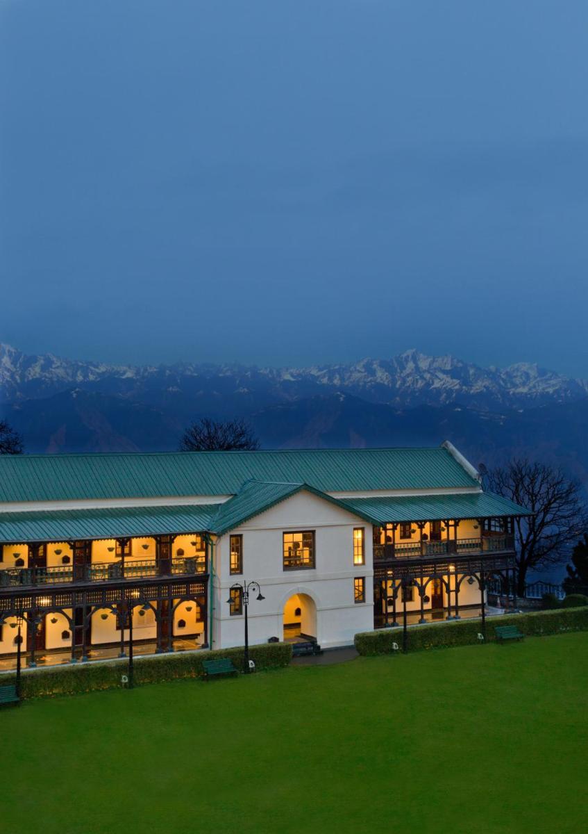 a large white building with a green roof at Welcomhotel by ITC Hotels, The Savoy, Mussoorie in Mussoorie