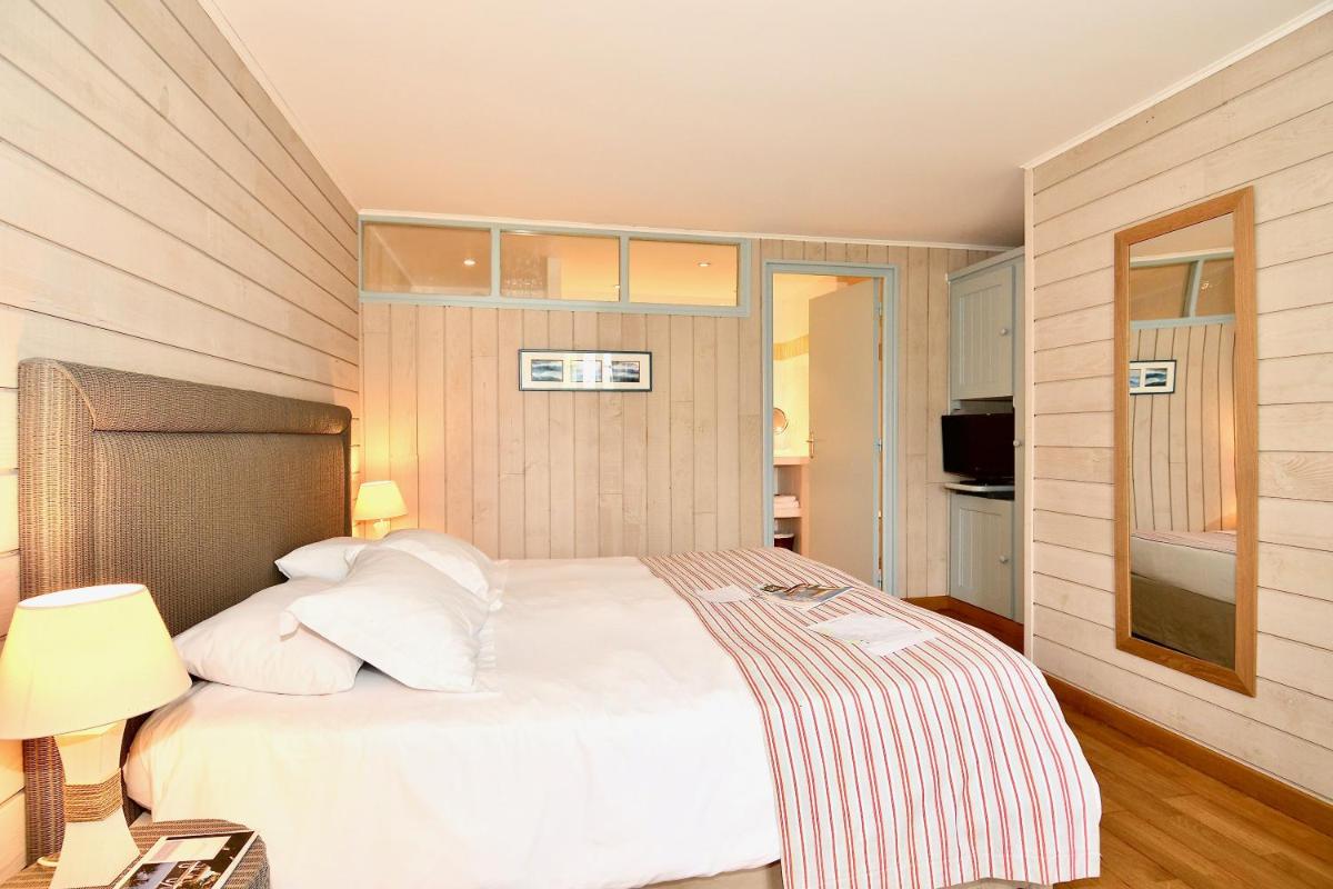 Un ou plusieurs lits dans un hébergement de l'établissement La Désirade - Hôtel, Spa & Restaurant