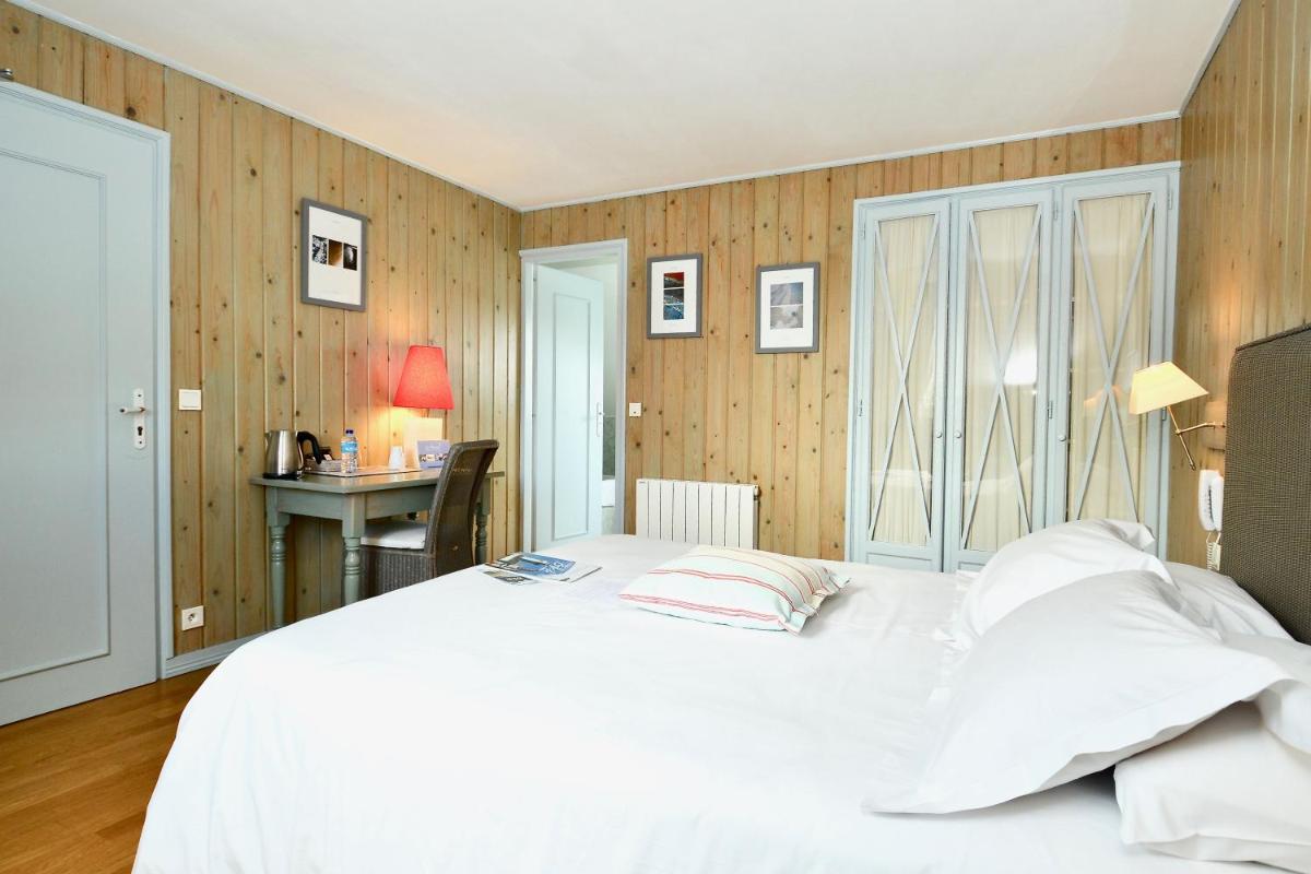 Un ou plusieurs lits dans un hébergement de l'établissement La Désirade - Hôtel, Spa & Restaurant